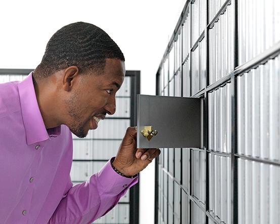 A man checking his PO Box.